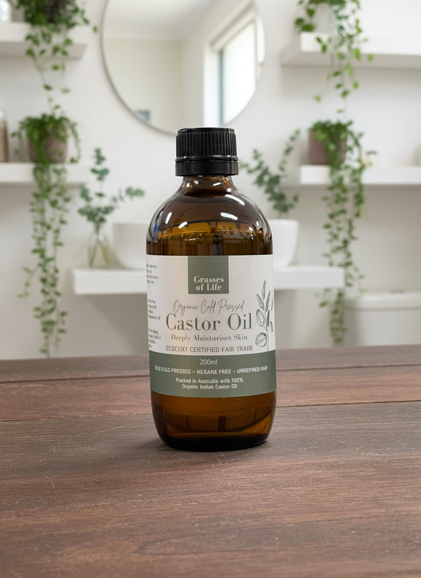Bottle of organic, hexane free castor oil on a wooden surface with shelves in the background