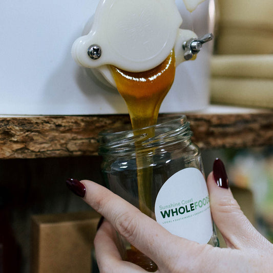 250ml Jar of local raw honey being refilled