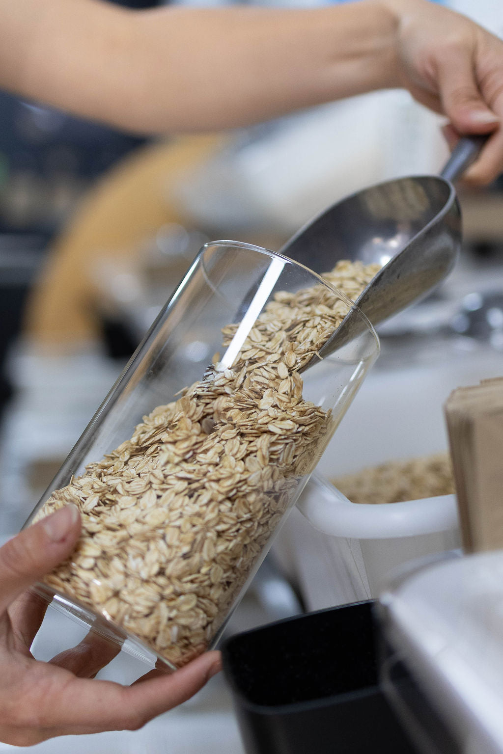 Refilling glass jar with 100% natural wholegrain oats | organic whole food shopping
