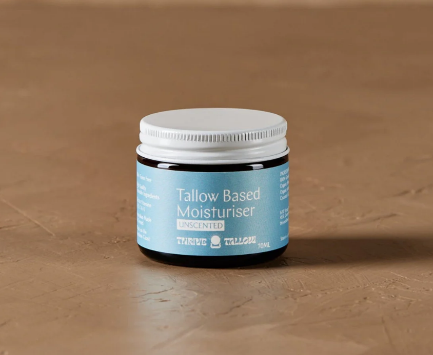 Jar of tallow-based moisturizer on a brown background