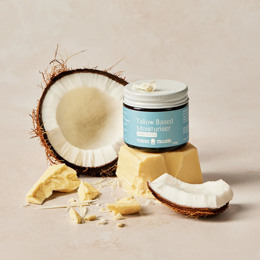 Jar of Tallow-Based Moisturizer with coconut and tallow on a neutral background